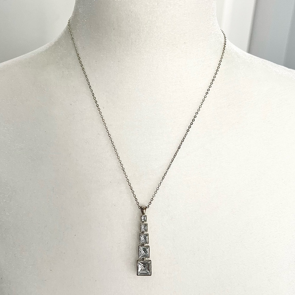 Tapered rhinestone studded pendant necklace on a silver tone chain